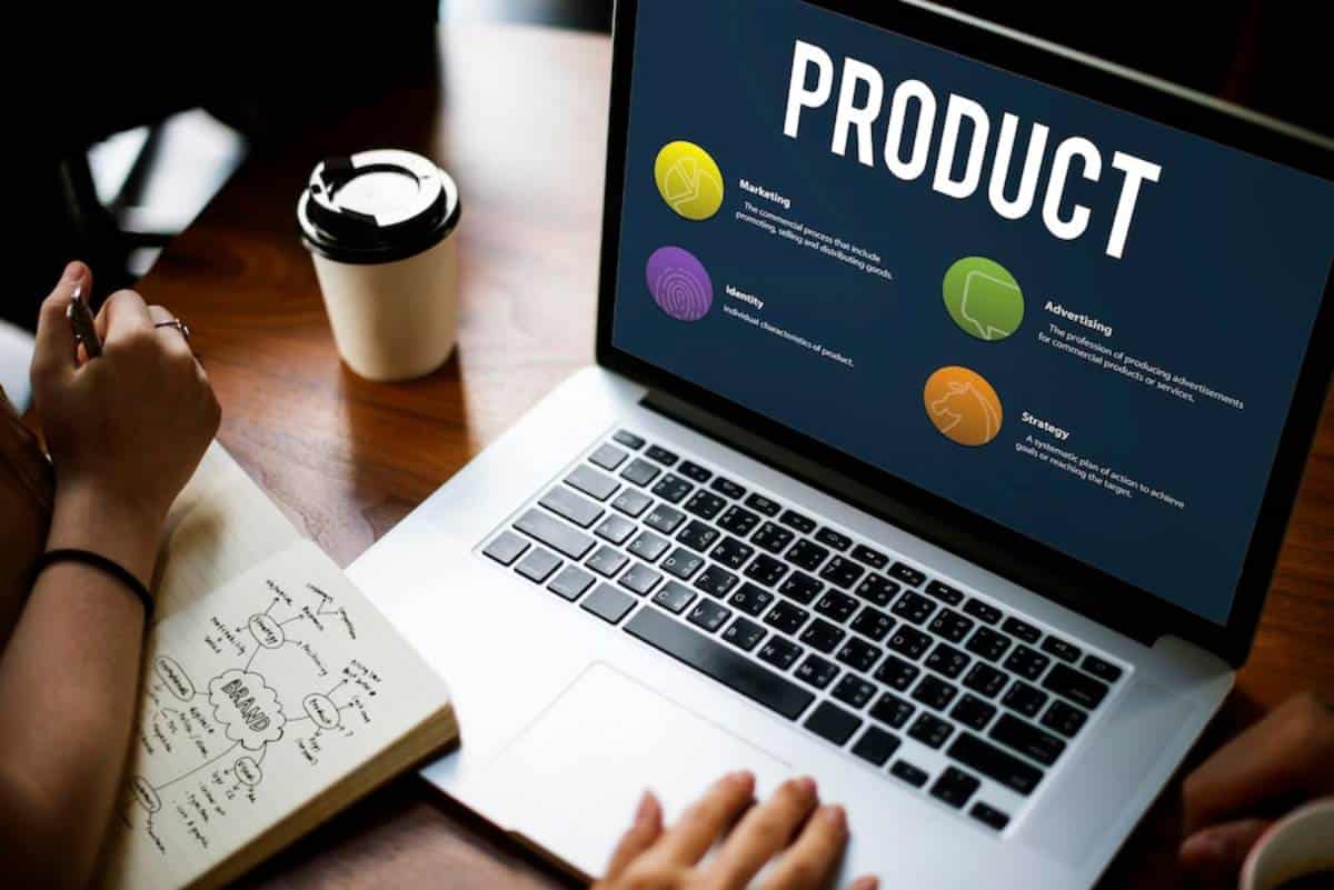 Person working on a laptop displaying a presentation labeled "PRODUCT" with icons for marketing, identity, advertising, and strategy.