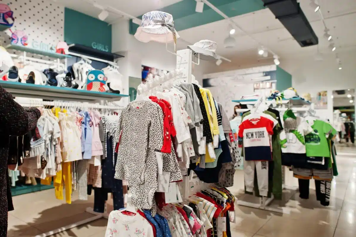 A vibrant children’s clothing section in a store, displaying various outfits and accessories.