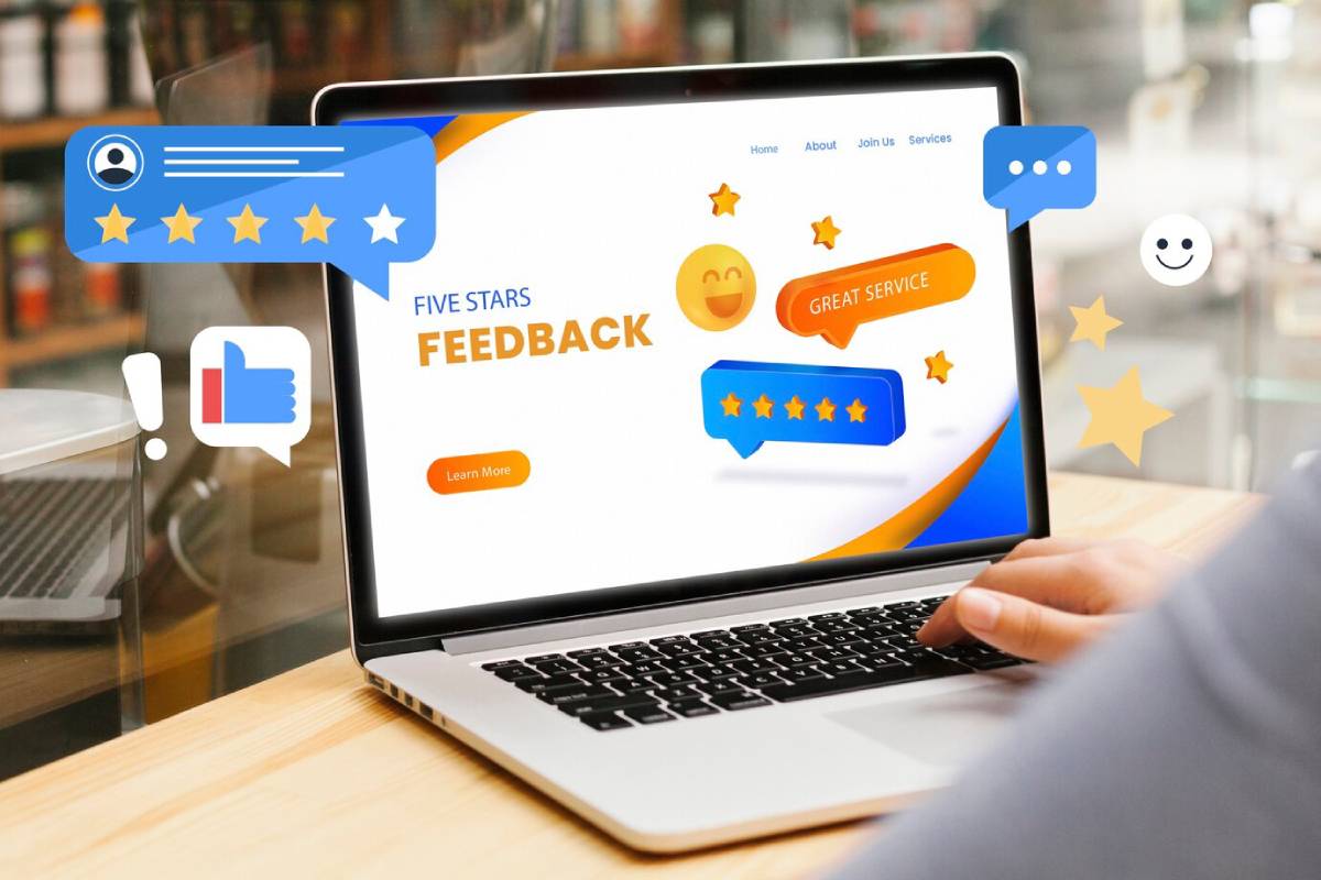 Laptop screen showing a vibrant feedback and rating webpage with graphics of stars and comments.