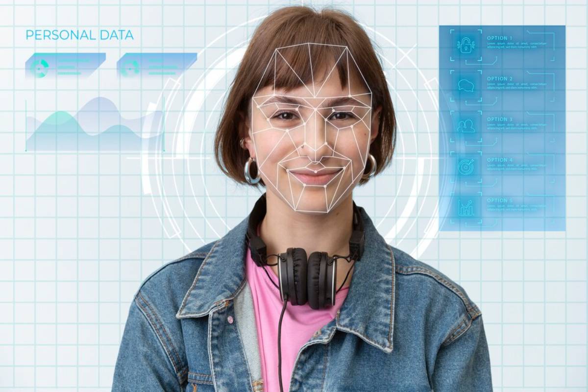 Young woman with facial recognition technology mapping her face, against a digital interface background displaying personal data.